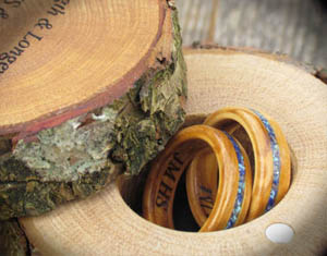 two wooden rings in a rustic ring box